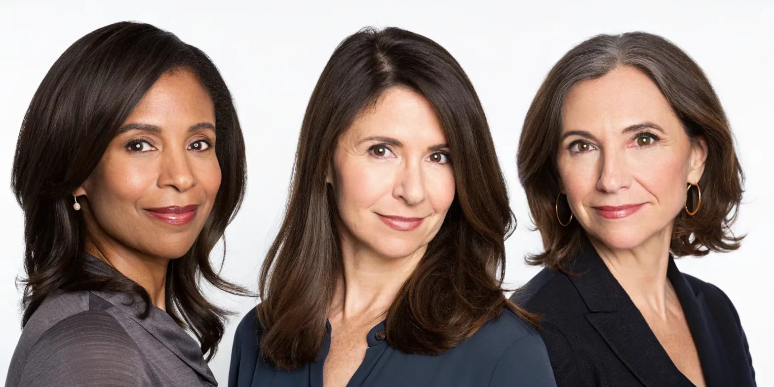Three women with healthy, vibrant dark brown hair in a variety of shades and styles.